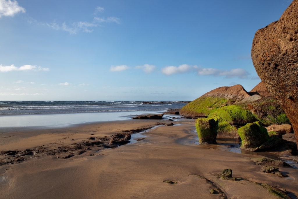 Dark brown sands of Playa La Jaquita