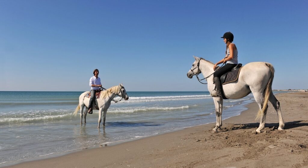 People horseback-riding in Playa Hermosa