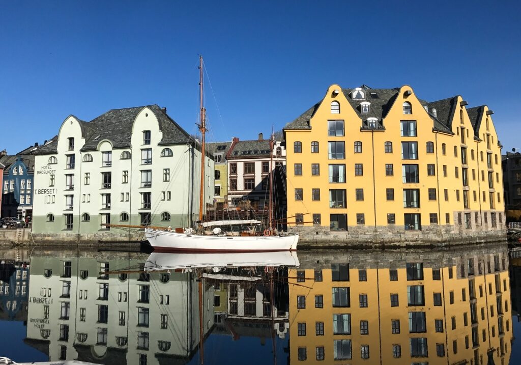 Beautiful buildings of Downtown Ålesund, Norway reflecting on water