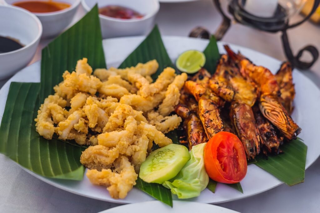 Fried seafood on banana leaves at a restaurant in Jimbaran, Bali