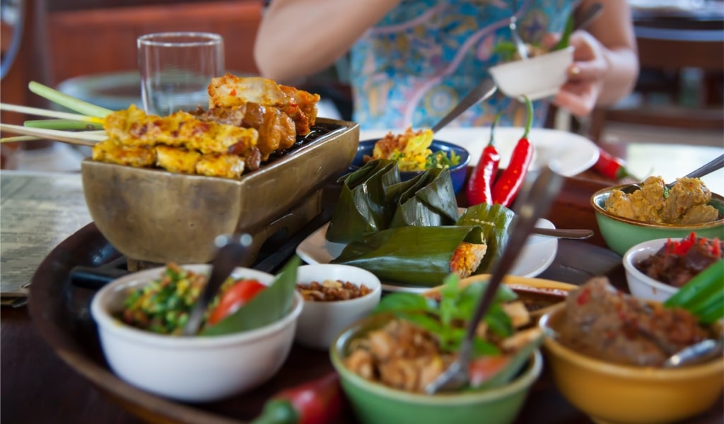 Person enjoying Bali food at a restaurant