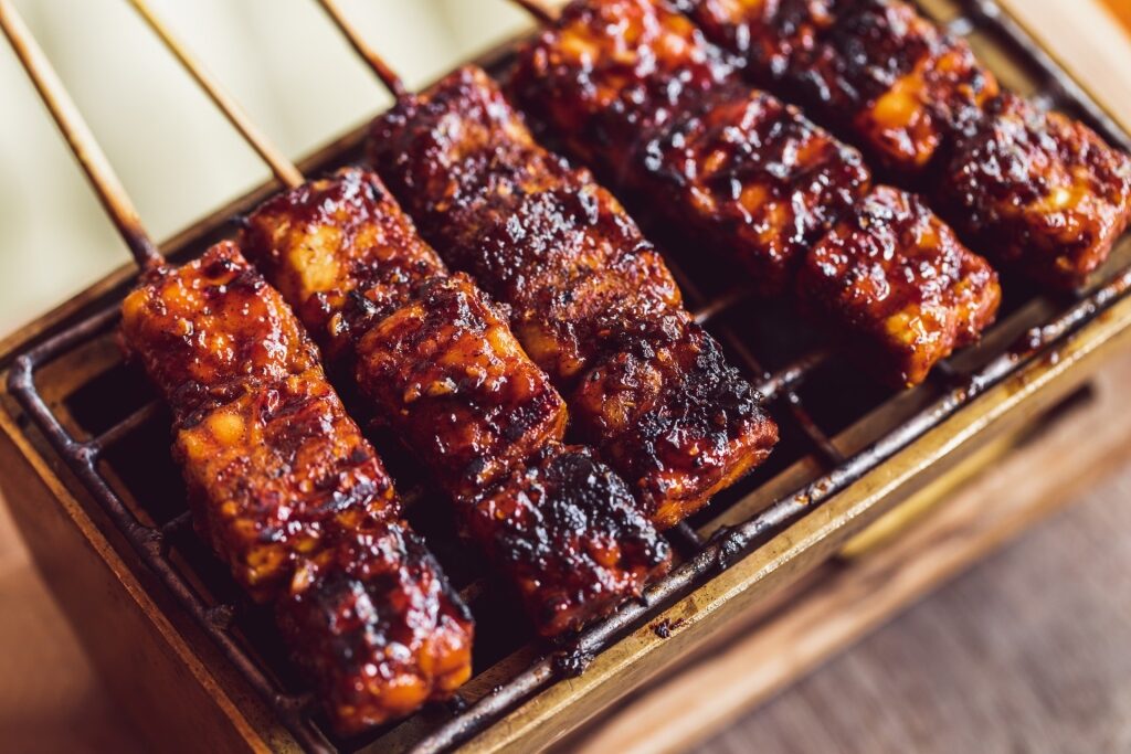 Savory tempeh skewers on a platter