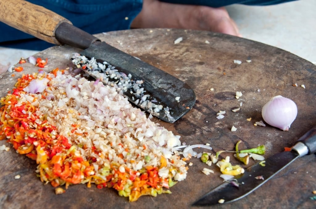 Man chopping Sambal matah