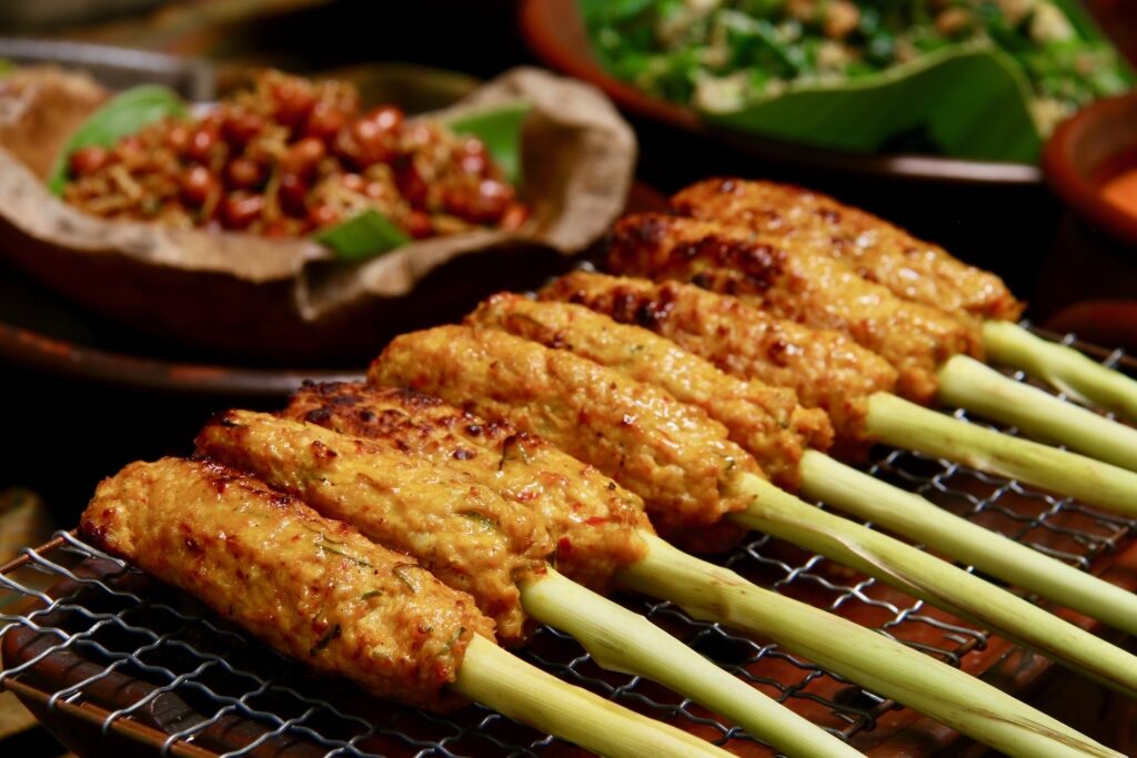Tasty sate lilit skewers on a tray