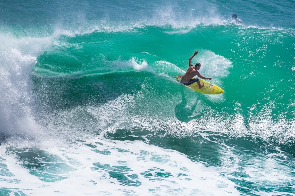 Man surfing in Padang Padang Beach