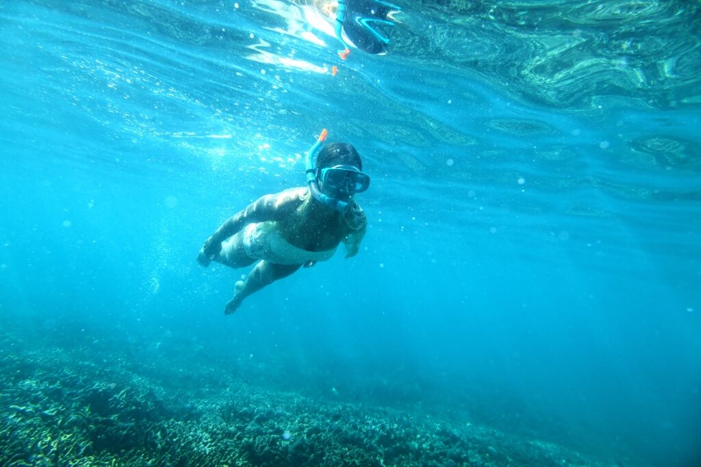Woman snorkeling in the Green Bowl Beach