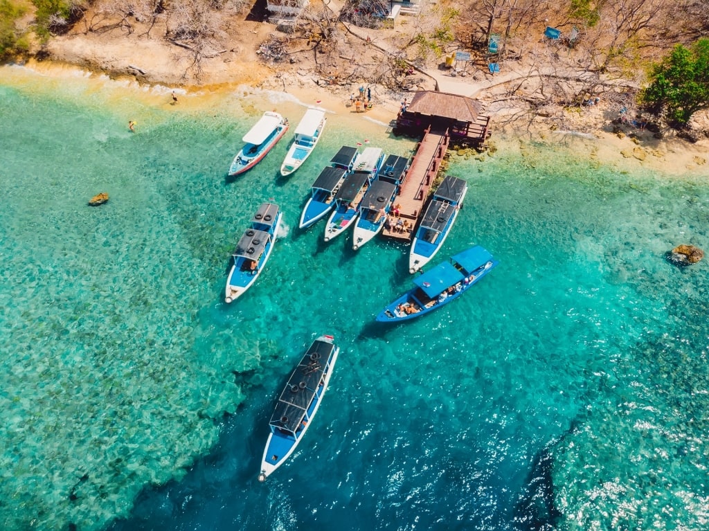 Clear blue waters of Menjangan Island with boats