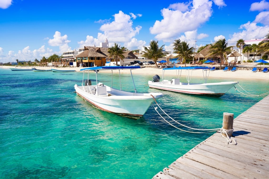 Clear water of Playa Morelos, Puerto Morelos with boats