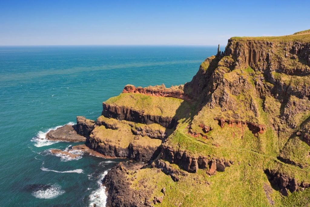 Cliffside view of Causeway Coast Way, near Belfast with view of the water