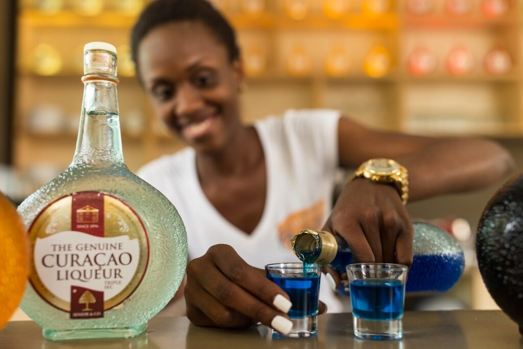 Woman pouring liquor at the Curaçao Liqueur Distillery in Willemstad