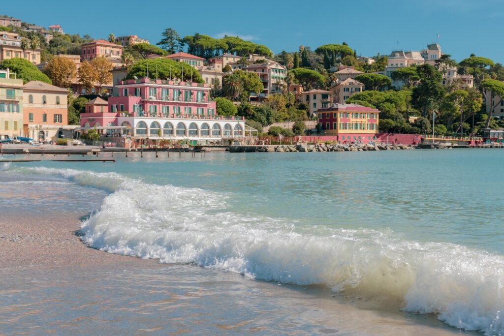 Soft waves at a beach with colorful waterfront
