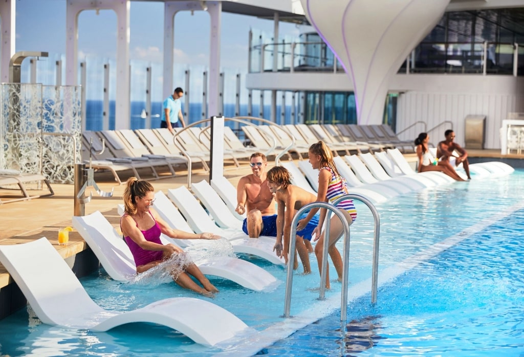 Family by the pool aboard Celebrity Edge