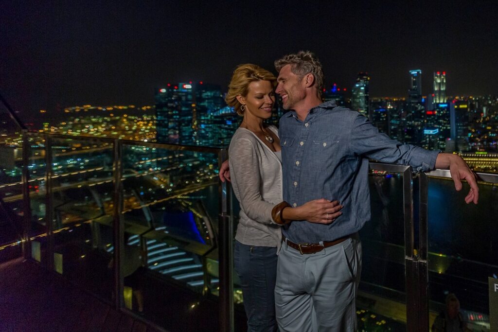 Couple enjoying the view from Sands SkyPark at night