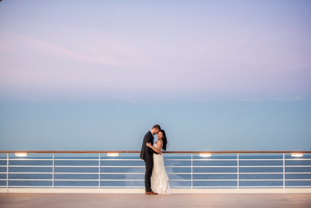 Married couple standing on a cruise ship