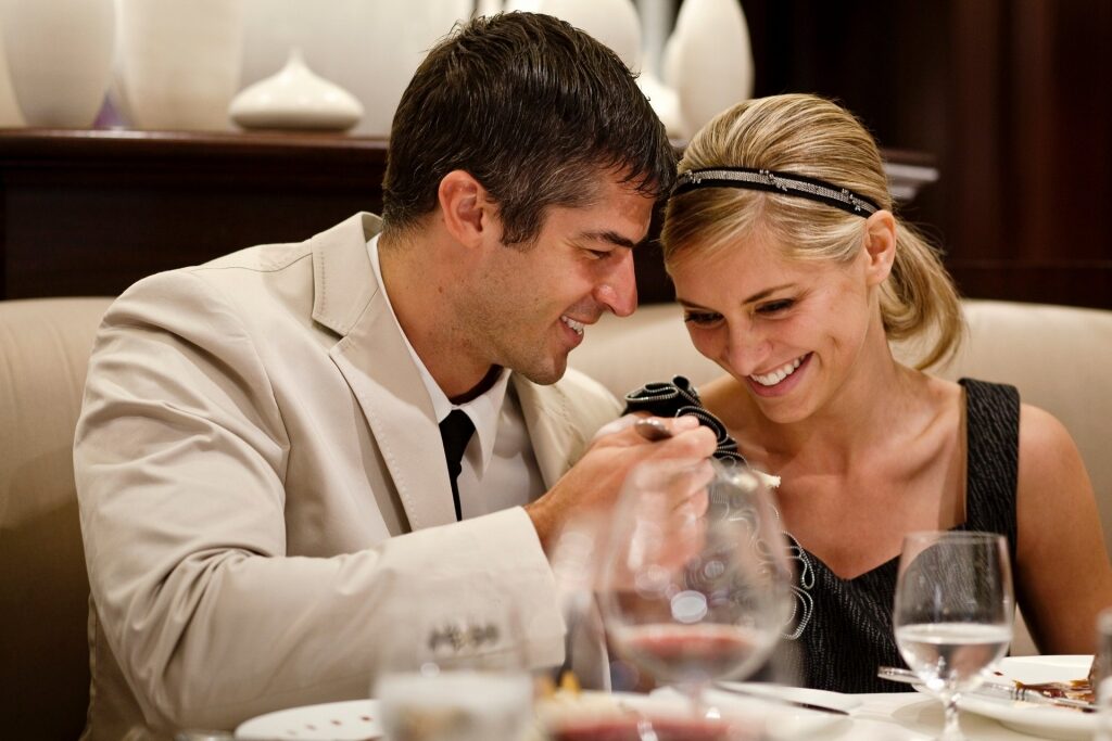 Couple eating at a restaurant aboard Celebrity Cruises