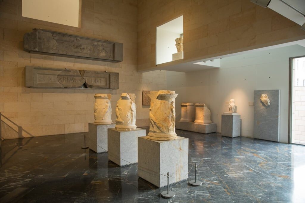 Historic columns and statues inside the Roman Theater Museum