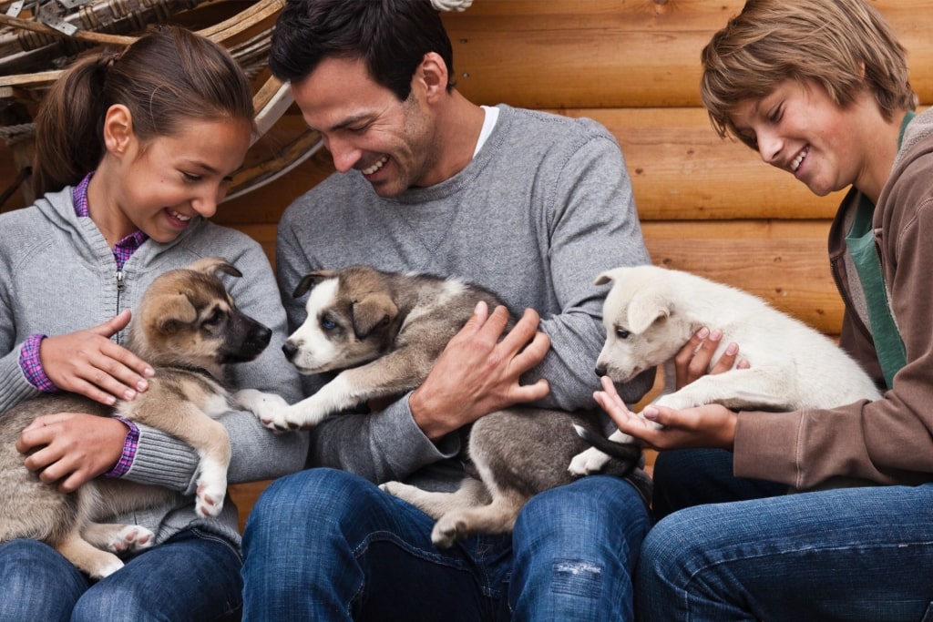 Family petting huskies from Husky Homestead, Denali National Park