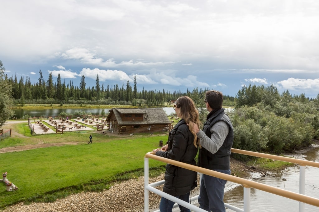 Couple looking at the Trailbreaker Kennel, Fairbanks from a boat