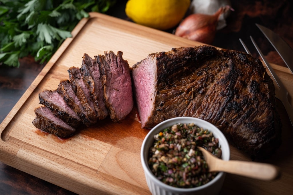 Slices of asado on a wooden board