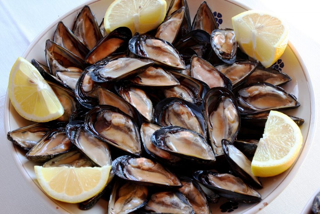Mussels on a plate drizzled with lemon