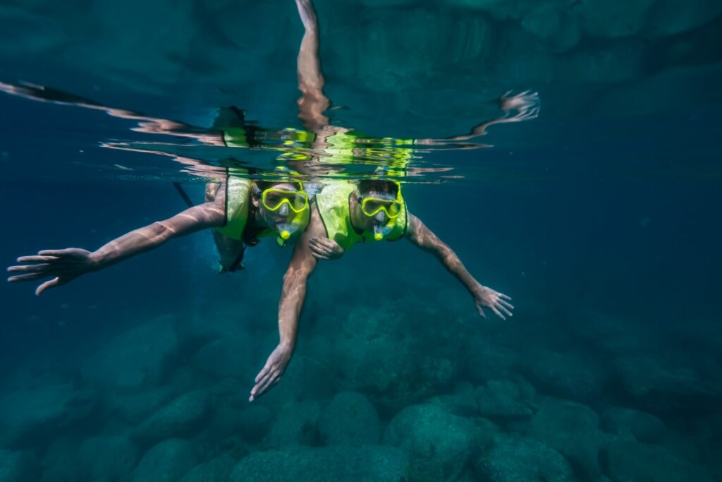 Couple snorkeling in deep blue water
