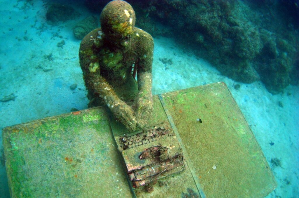 The writer sculpture in Molinere Underwater Sculpture Park, Grenada