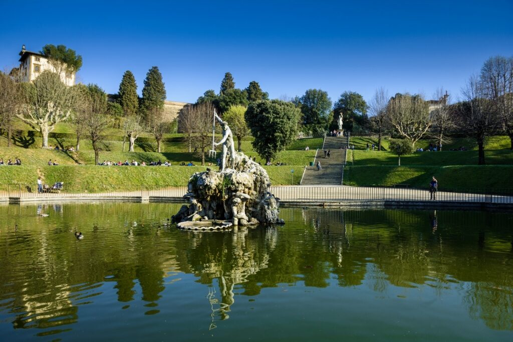 Lush landscape of Boboli Gardens with Fountain of Neptune