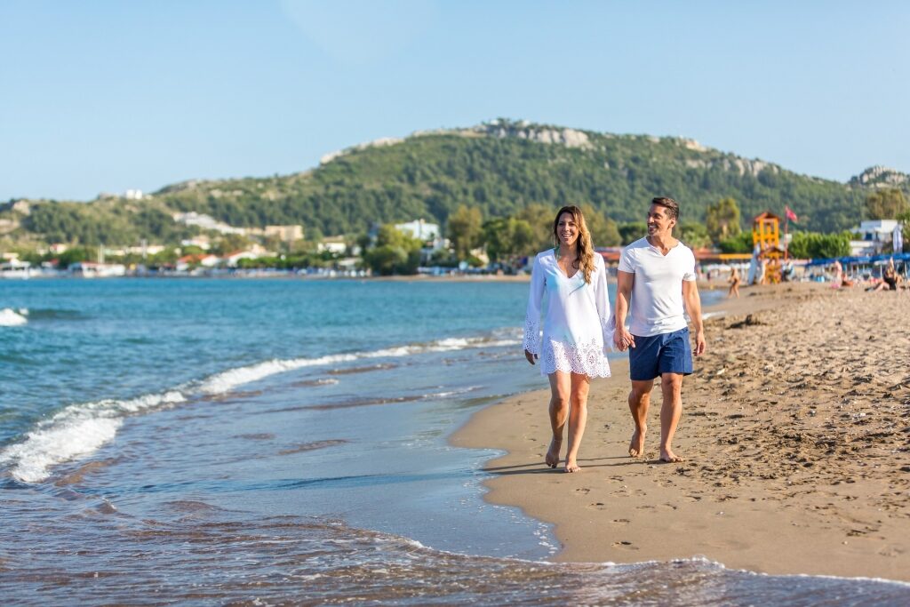 Couple walking on a beach in Rhodes, Greece