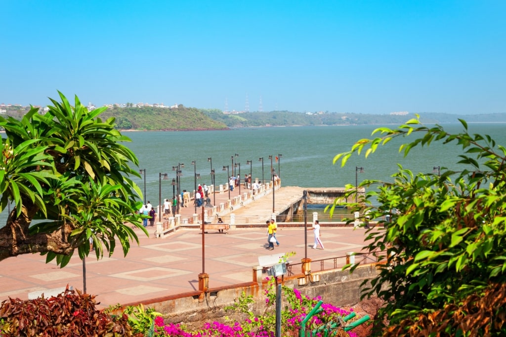 People strolling the boardwalk in Dona Paula Beach