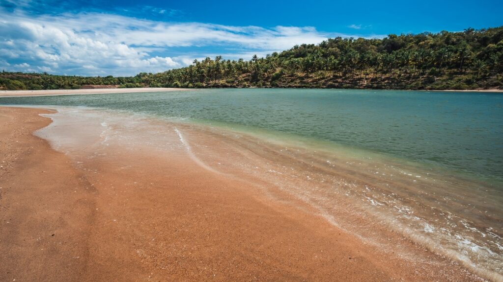 Brown sands of Galgibaga Beach with clear blue water