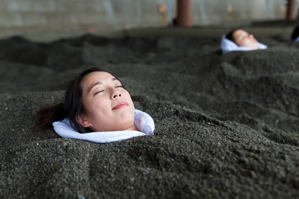 Woman trying out the Ibusuki sand baths