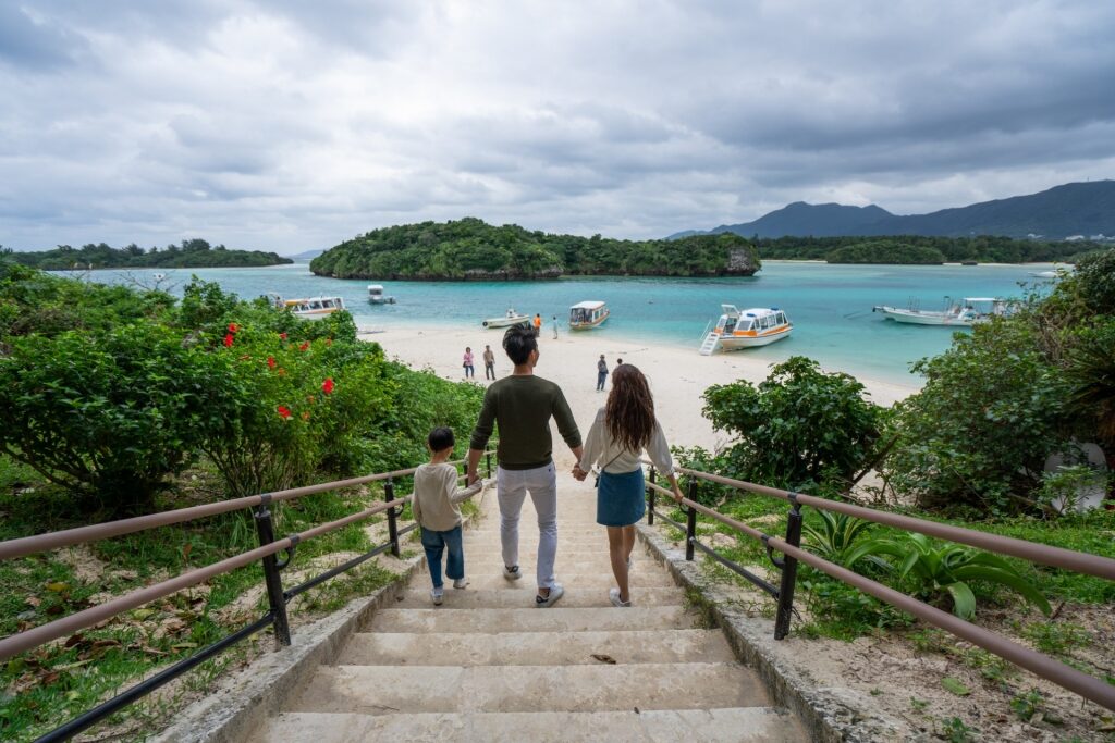 Family walking down the stairs with scenic view of Kabira Bay