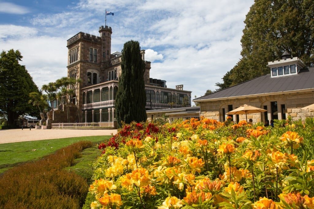 Elegant Larnach Castle with colorful garden in front
