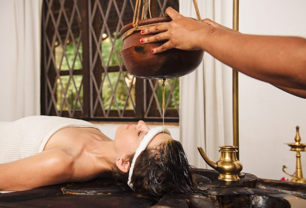 Woman getting a Shirodhara massage