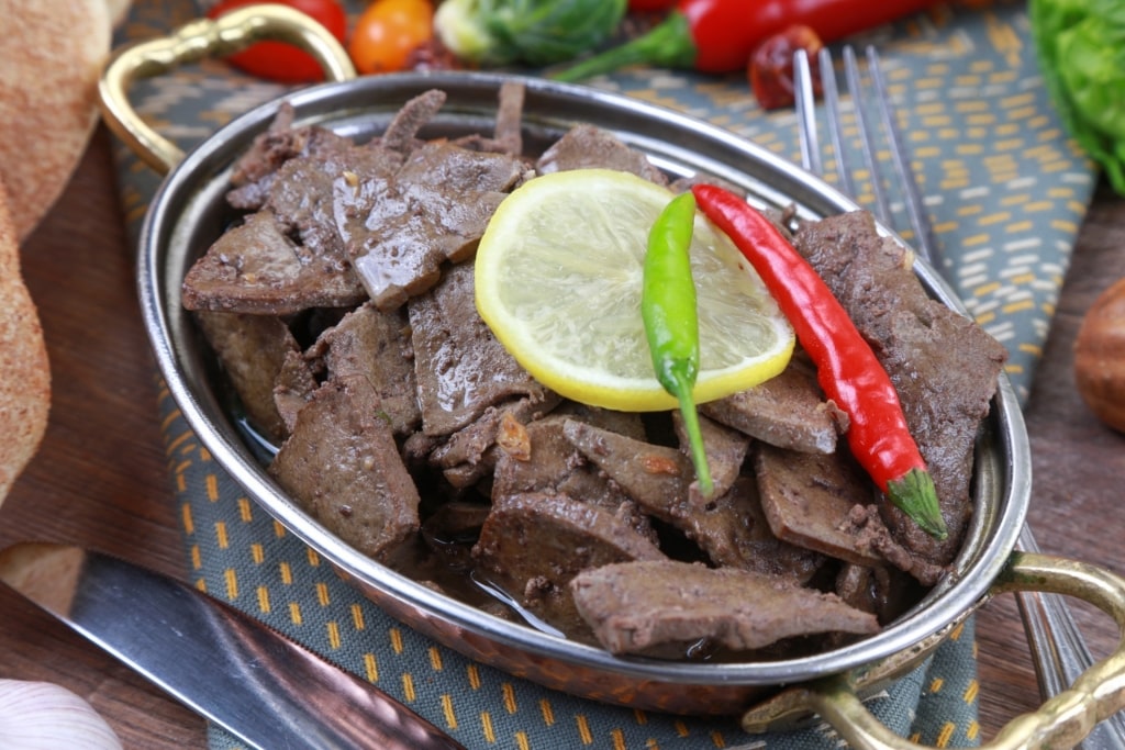 Bowl of Kebda Eskandarani (Alexandrian Liver) with chili on top