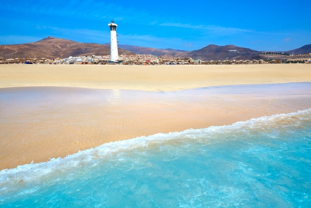 Sandy beach of Playa del Matorral with lighthouse