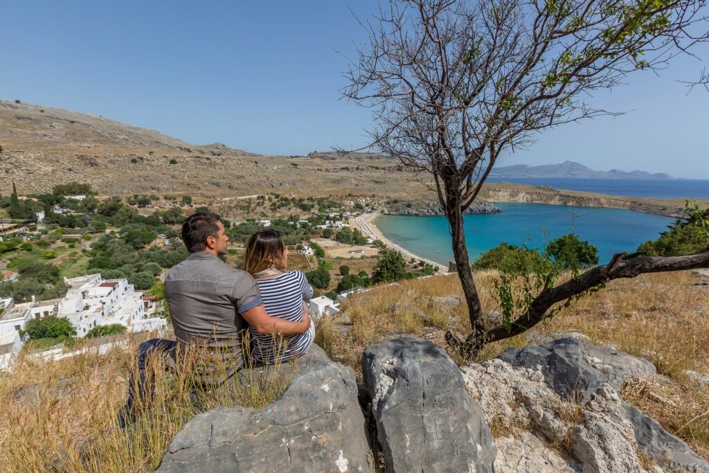 Couple sightseeing from Lindos Acropolis, one of the best hiking in Greece