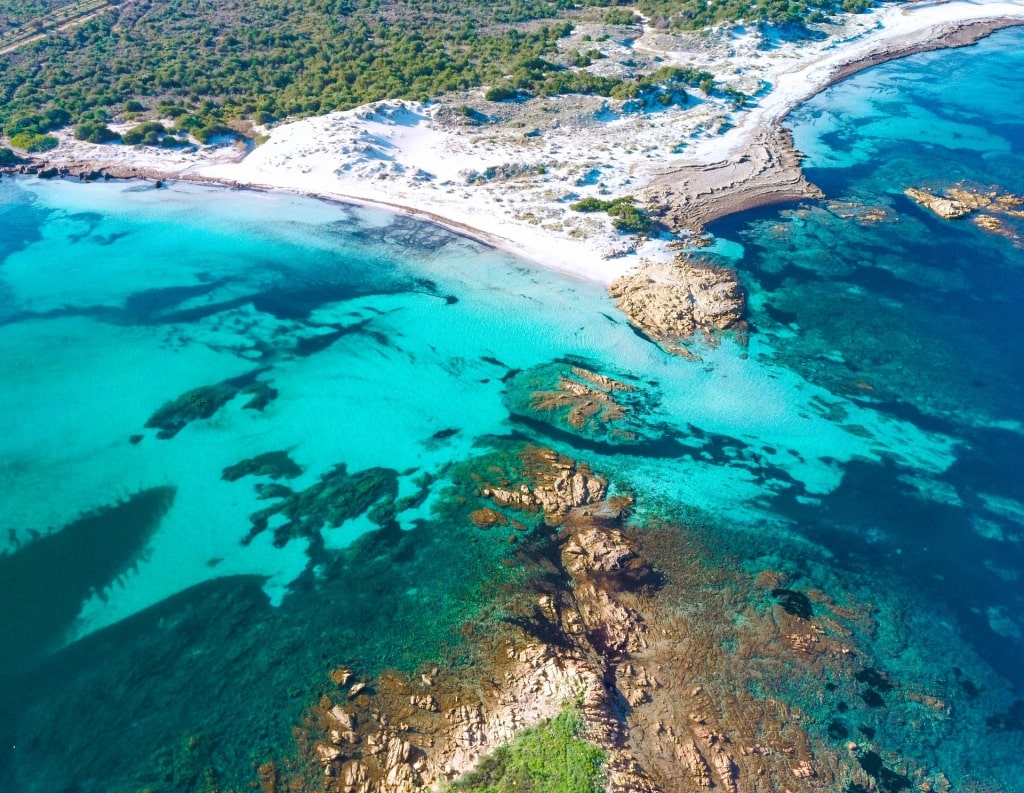 Rocky shoreline of Capo Comino Beach