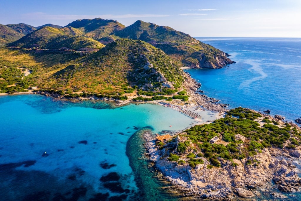 Lush landscape of Punta Molentis Beach with mountains