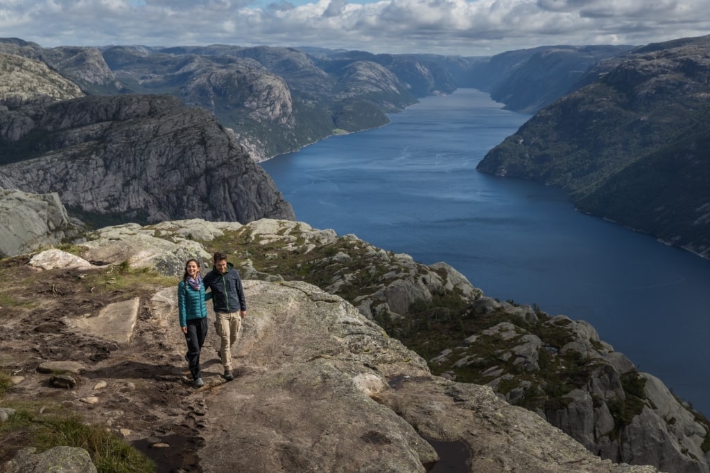 Couple sightseeing from Preikestolen Pulpit Rock in Norway