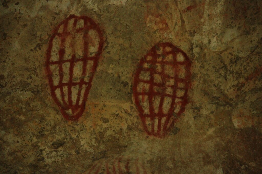 Indigenous rock art inside a cave in Nara Inlet