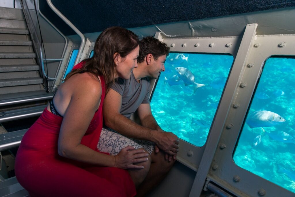 Couple on a glass bottom boat in Great Barrier Reef