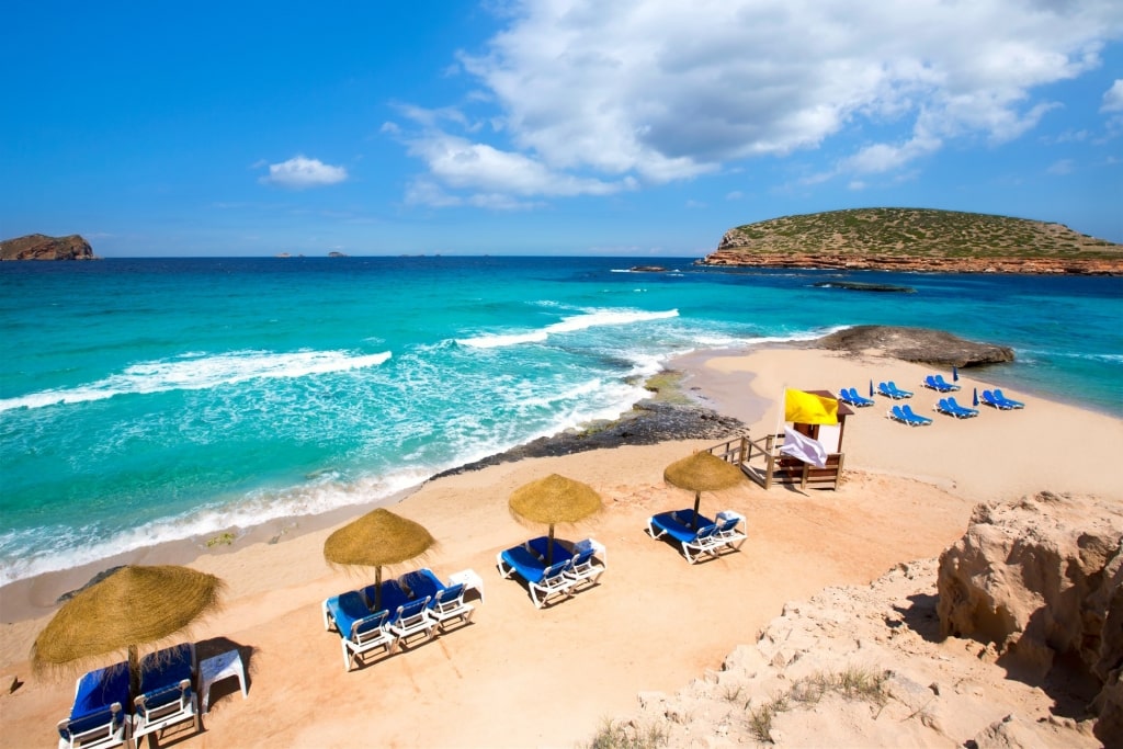 Umbrellas lined up on Cala Conta Beach