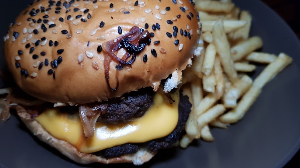 Chimichurri burger with fries on the side