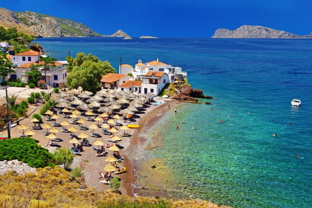 Umbrellas lined up on a beach in Hydra