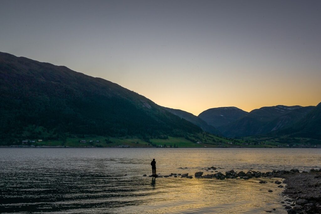Man fishing in Hornindalsvatn, near Olden