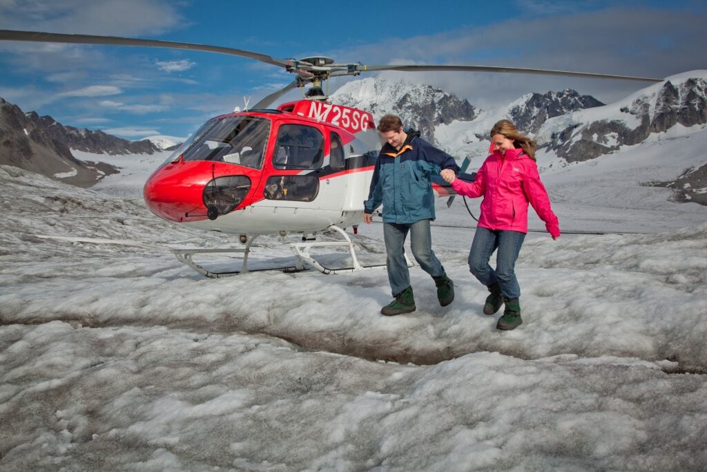 Couple exploring atop a glacier in Alaska