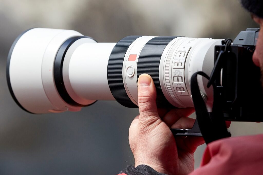 Man taking a photo with telephoto lens