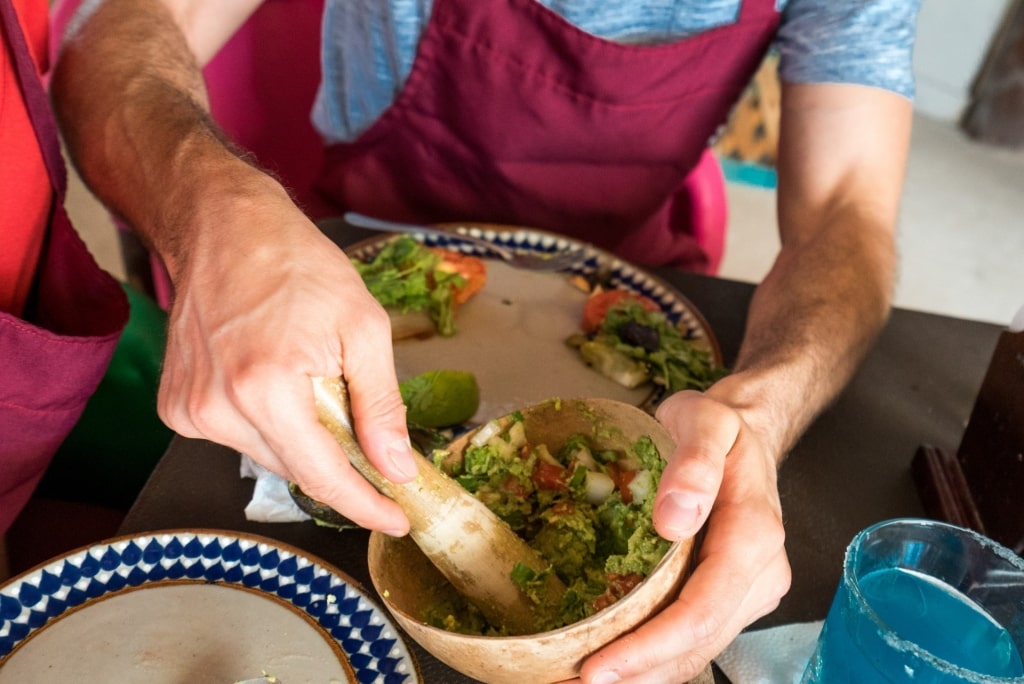 Person making guacamole