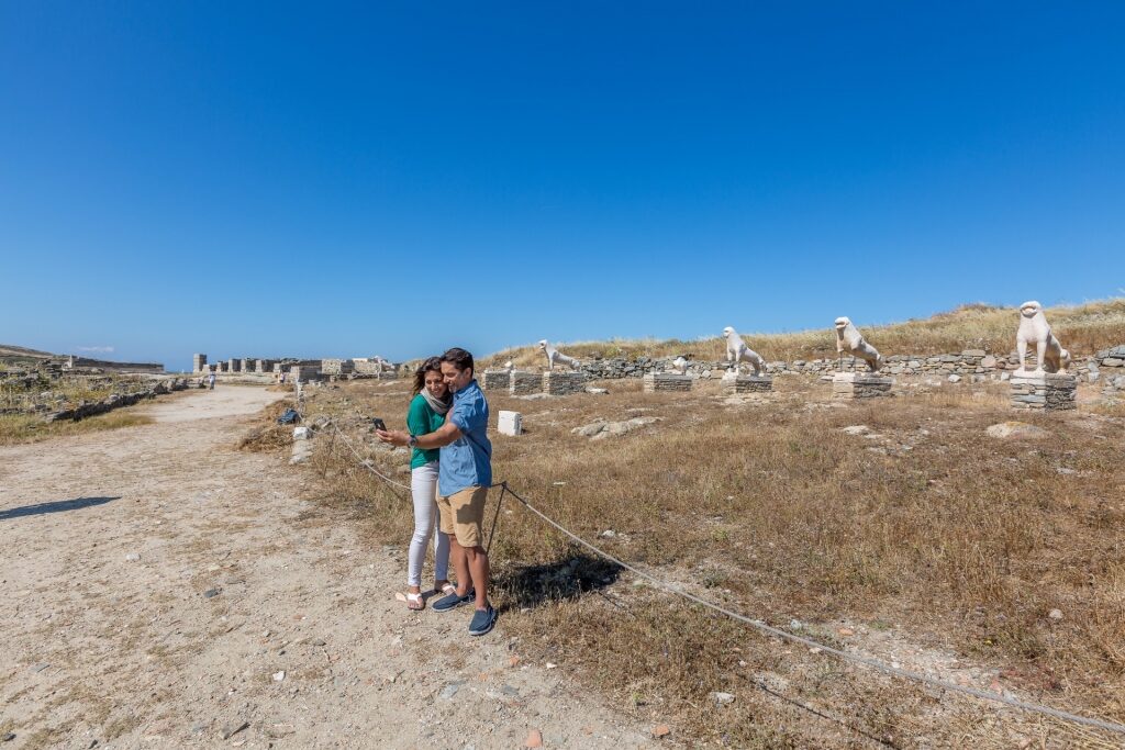 Couple taking a photo by the Terrace of the Lions, Delos